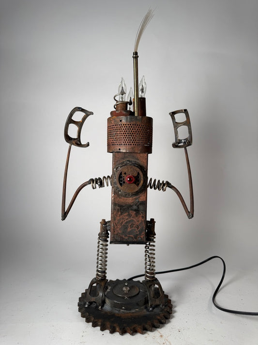 Hangry original sculptural lighting by Bobby Anderson with spring-loaded arms and legs, flickering bulbs, and glowing reclaimed metal body