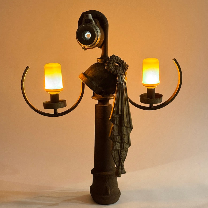 Goddess Idea illuminated found object sculpture made from antique metal parts by Bobby Anderson