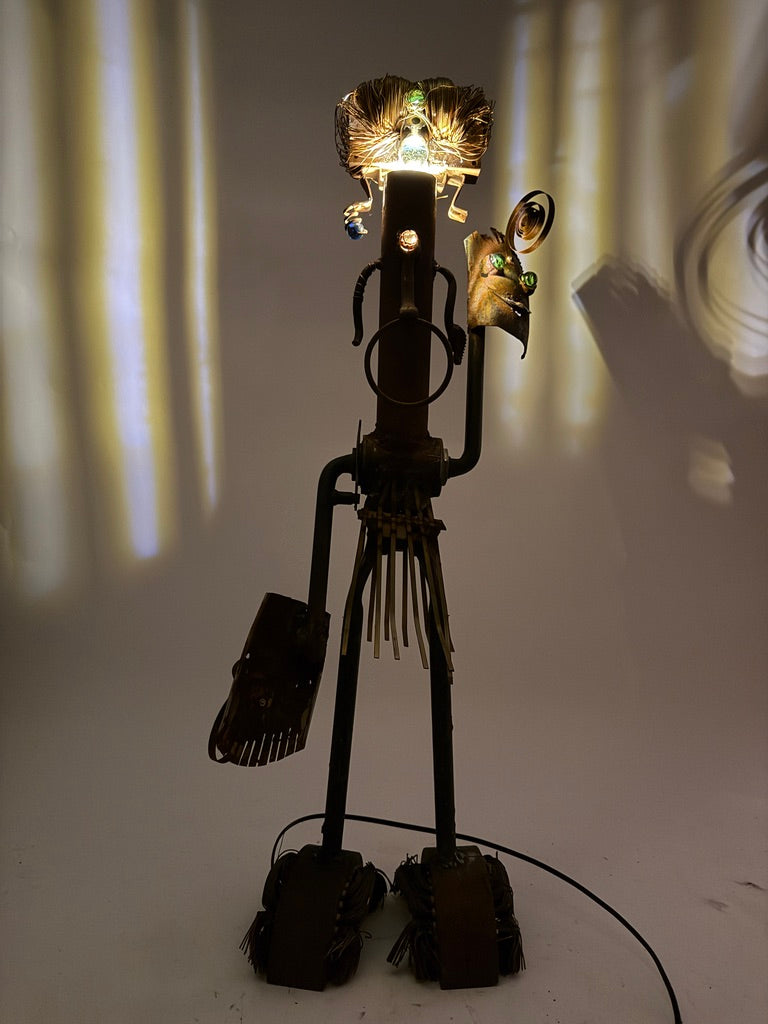 Shaman original sculptural lighting by Bobby Anderson with spinning mask arms, illuminated headdress, and reclaimed metal construction