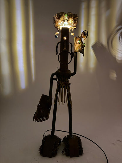 Shaman original sculptural lighting by Bobby Anderson with spinning mask arms, illuminated headdress, and reclaimed metal construction