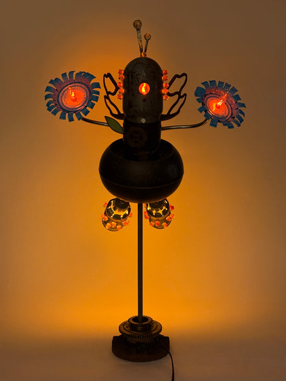 Firefly original sculptural robot lamp by Bobby Anderson with illuminated flower hands, glowing glass marbles, and reclaimed metal wings