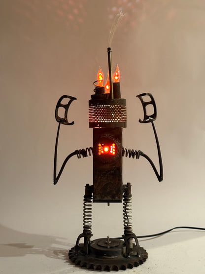 Hangry original sculptural lighting by Bobby Anderson with spring-loaded arms and legs, flickering bulbs, and glowing reclaimed metal body