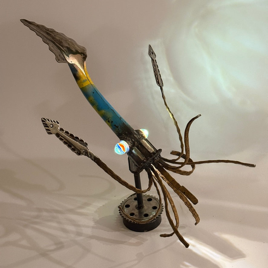 Illuminated Squid sculptural lamp casting underwater-style shadows through reclaimed metal