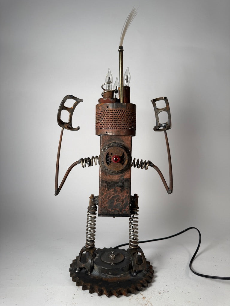 Hangry original sculptural lighting by Bobby Anderson with spring-loaded arms and legs, flickering bulbs, and glowing reclaimed metal body 