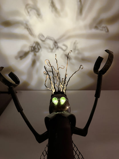 Kahuna original sculptural robot lamp by Bobby Anderson with magnetized hands, iron mesh cape, and projected ceiling light