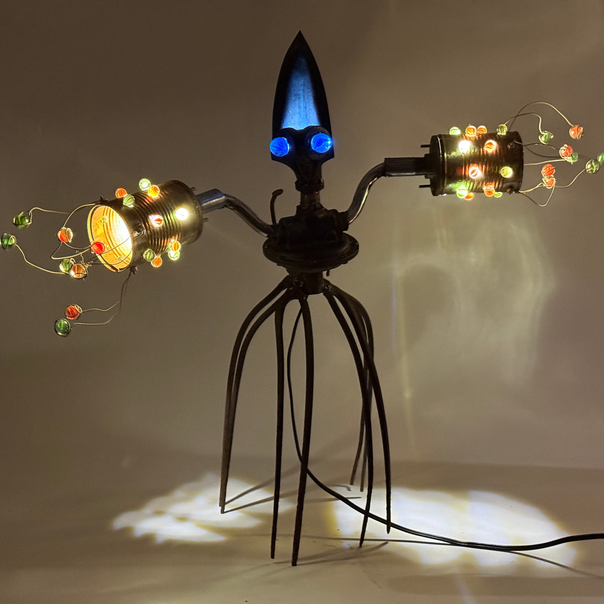 Scuttletron original alien robot lamp by Bobby Anderson, RVA246, with glowing marble lights, pitchfork legs, and reclaimed metal parts