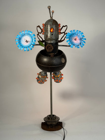 Firefly original sculptural robot lamp by Bobby Anderson with illuminated flower hands, glowing glass marbles, and reclaimed metal wings