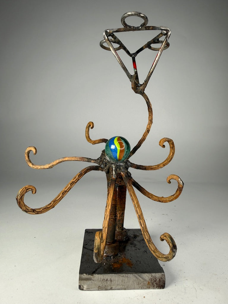 Octoholder functional reclaimed metal sculpture with curling arms and glass marble by Bobby Anderson
